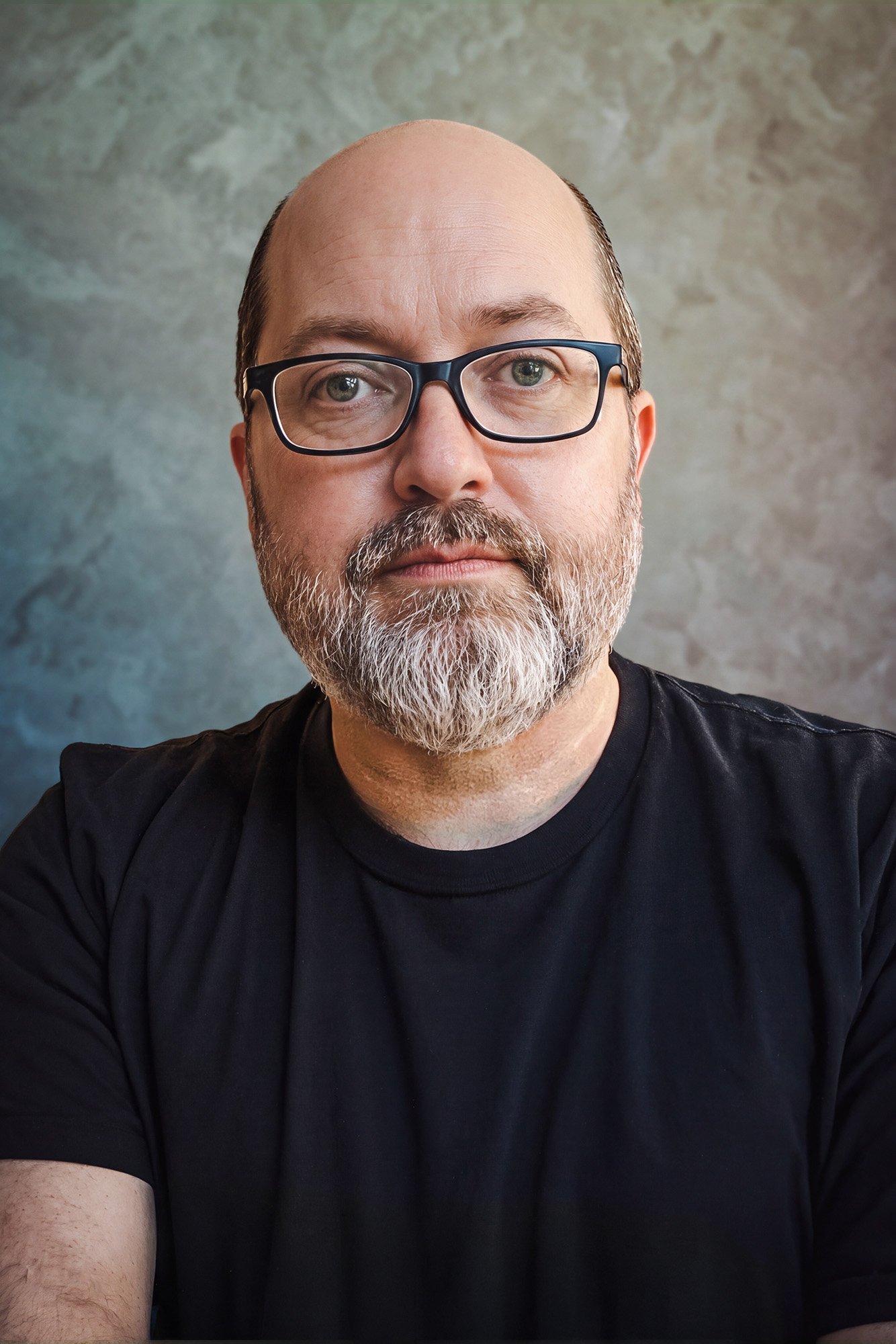 rmr-authprtrt26 Balding, bearded person in glasses and black t-shirt